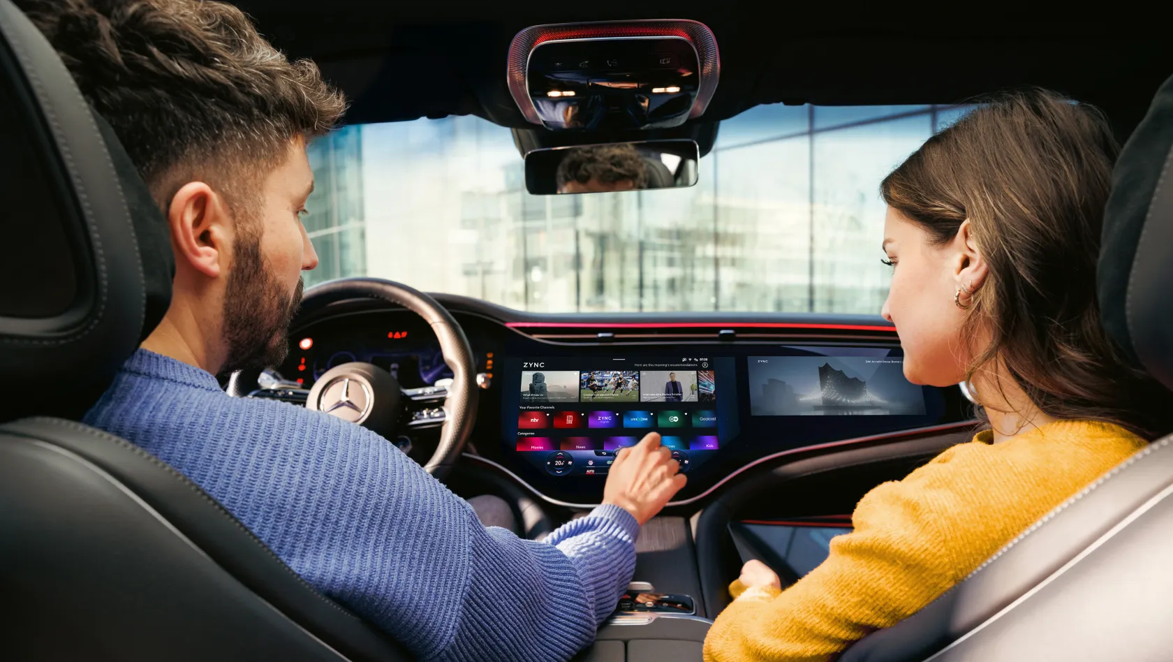 Driver and front passenger operating the hyperscreen in the vehicle
