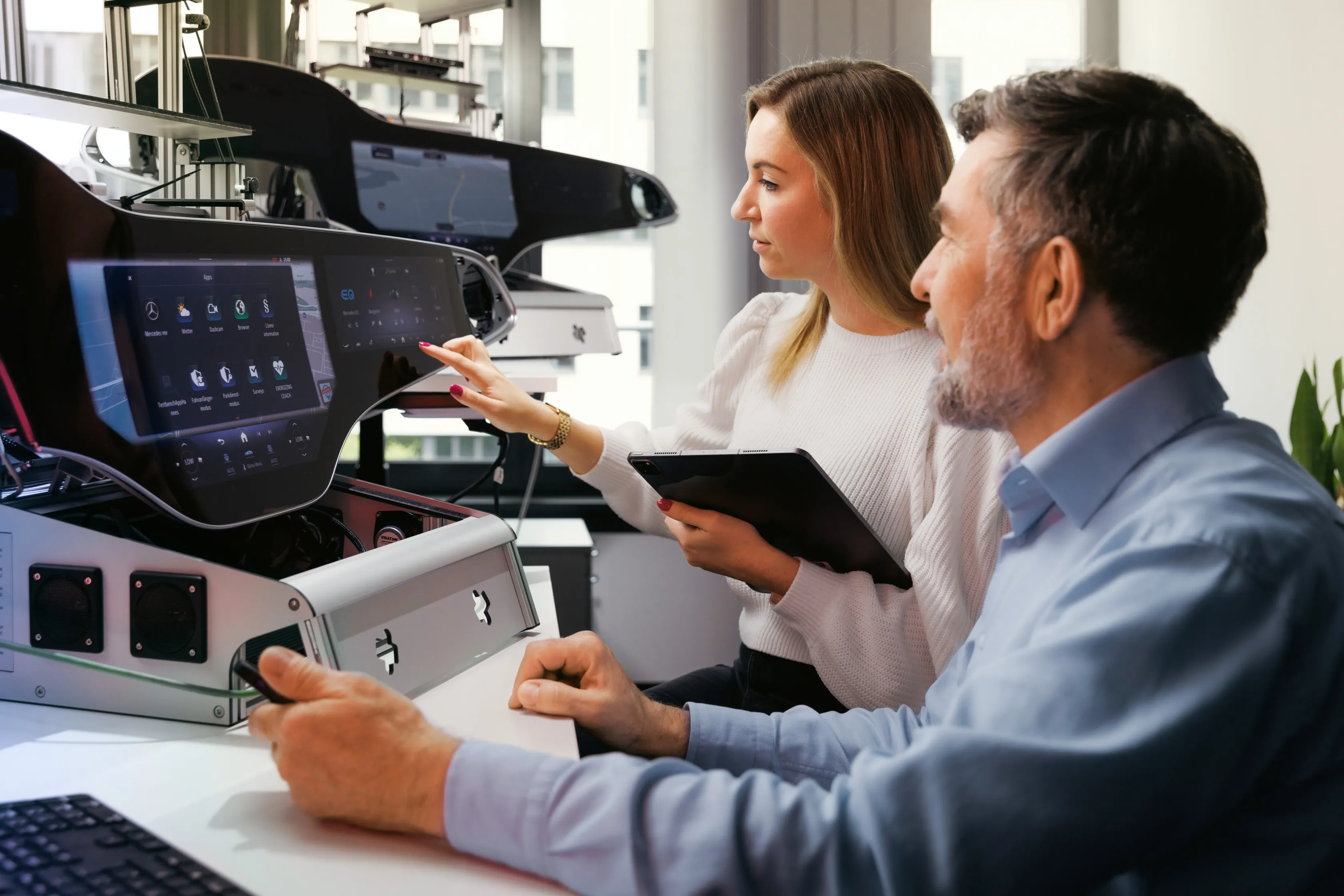 Two people testing the hyperscreen on a test bench