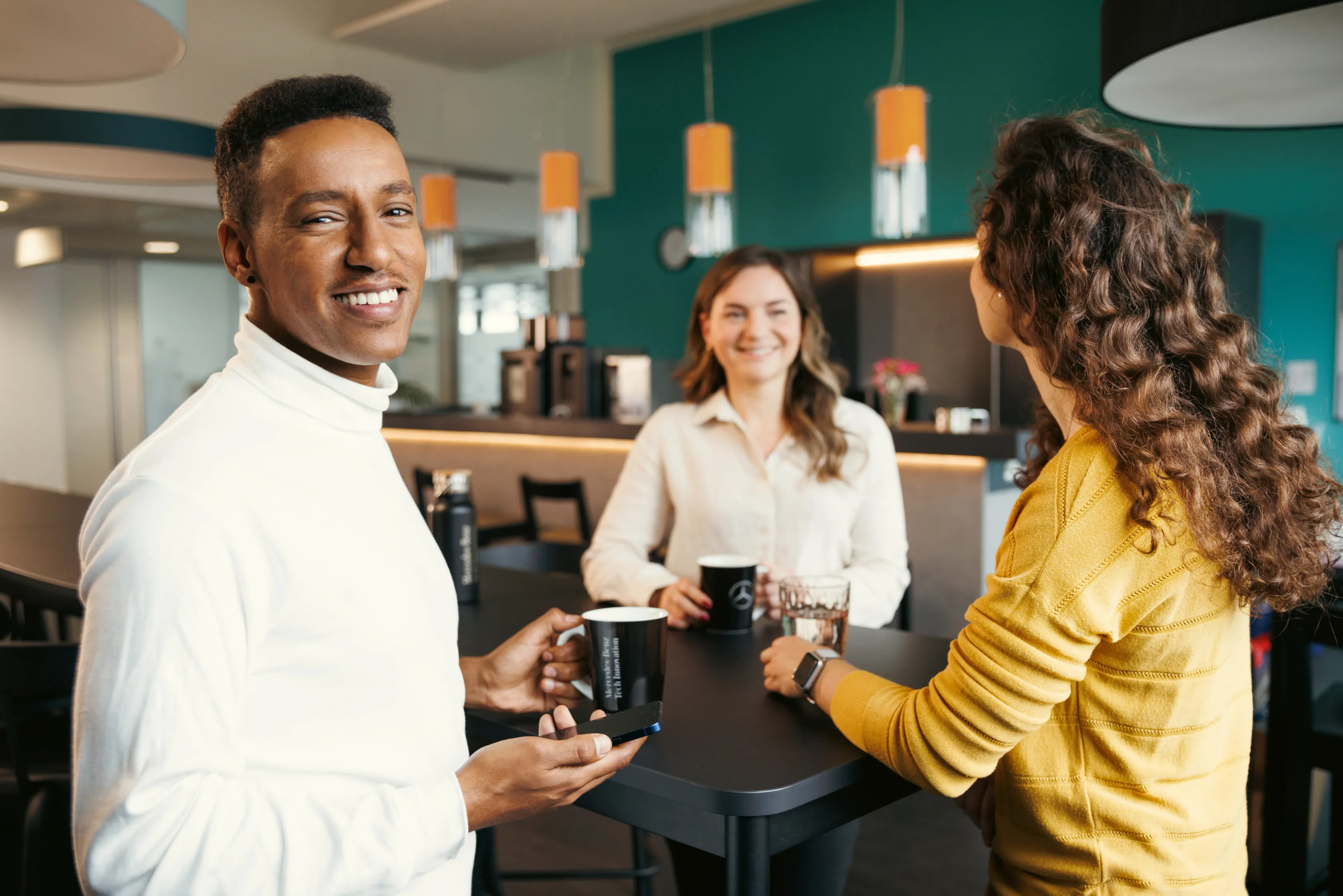 Three people talking at a table