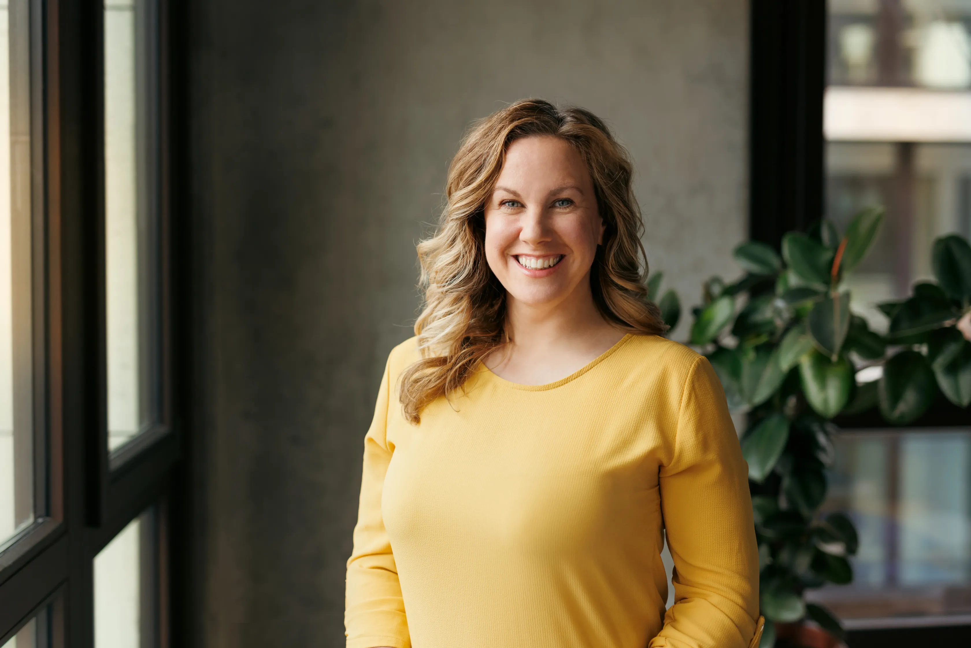 Portrait of a female colleague in a yellow sweater