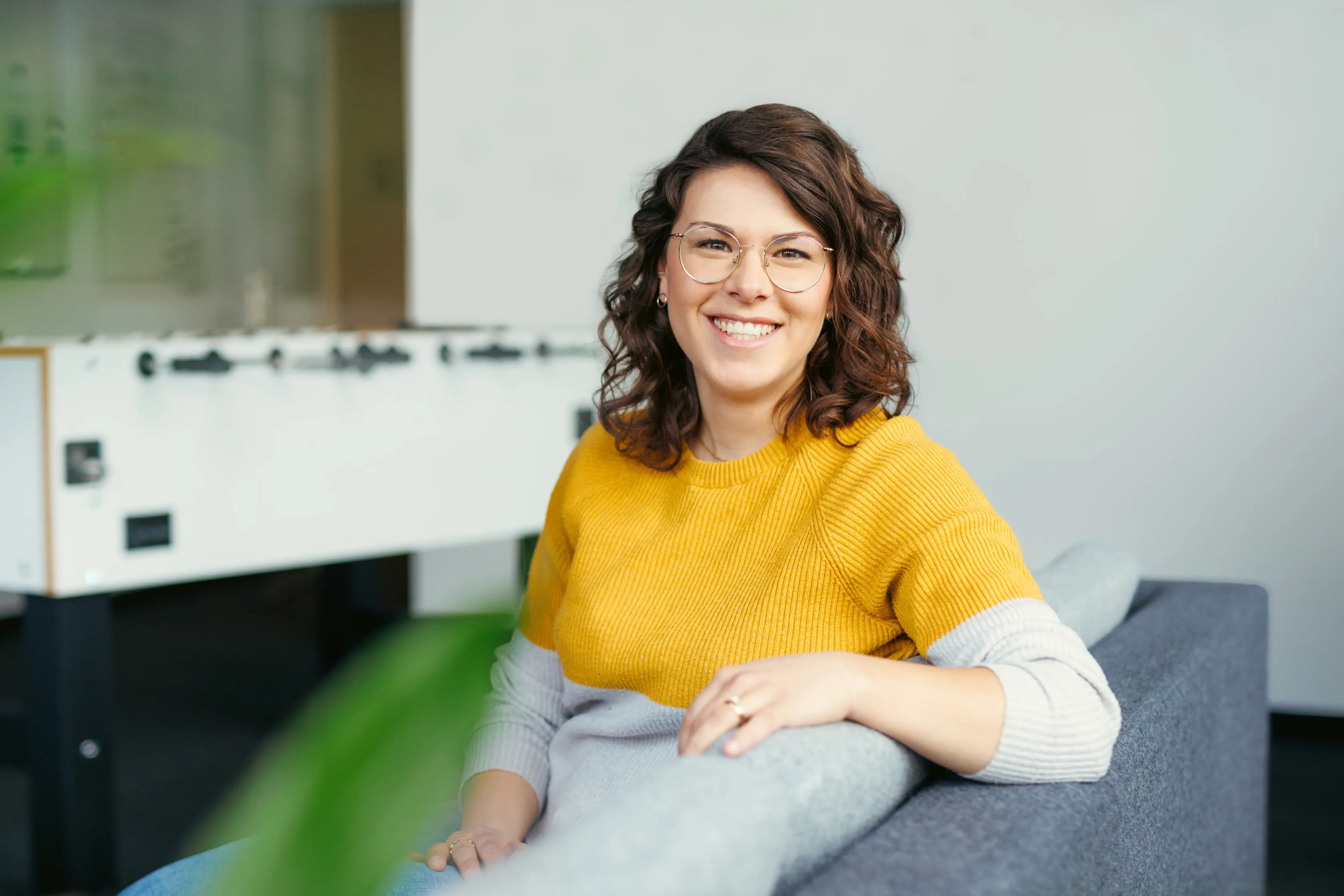 Cheerful female colleague on a sofa